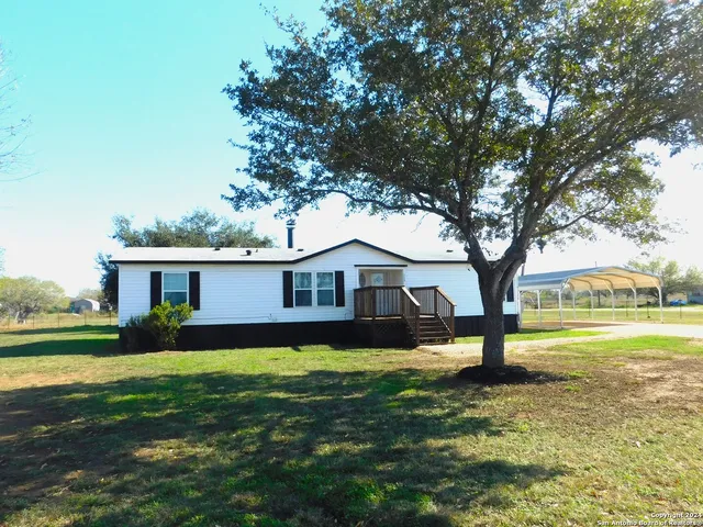 a house view with a sitting space and garden