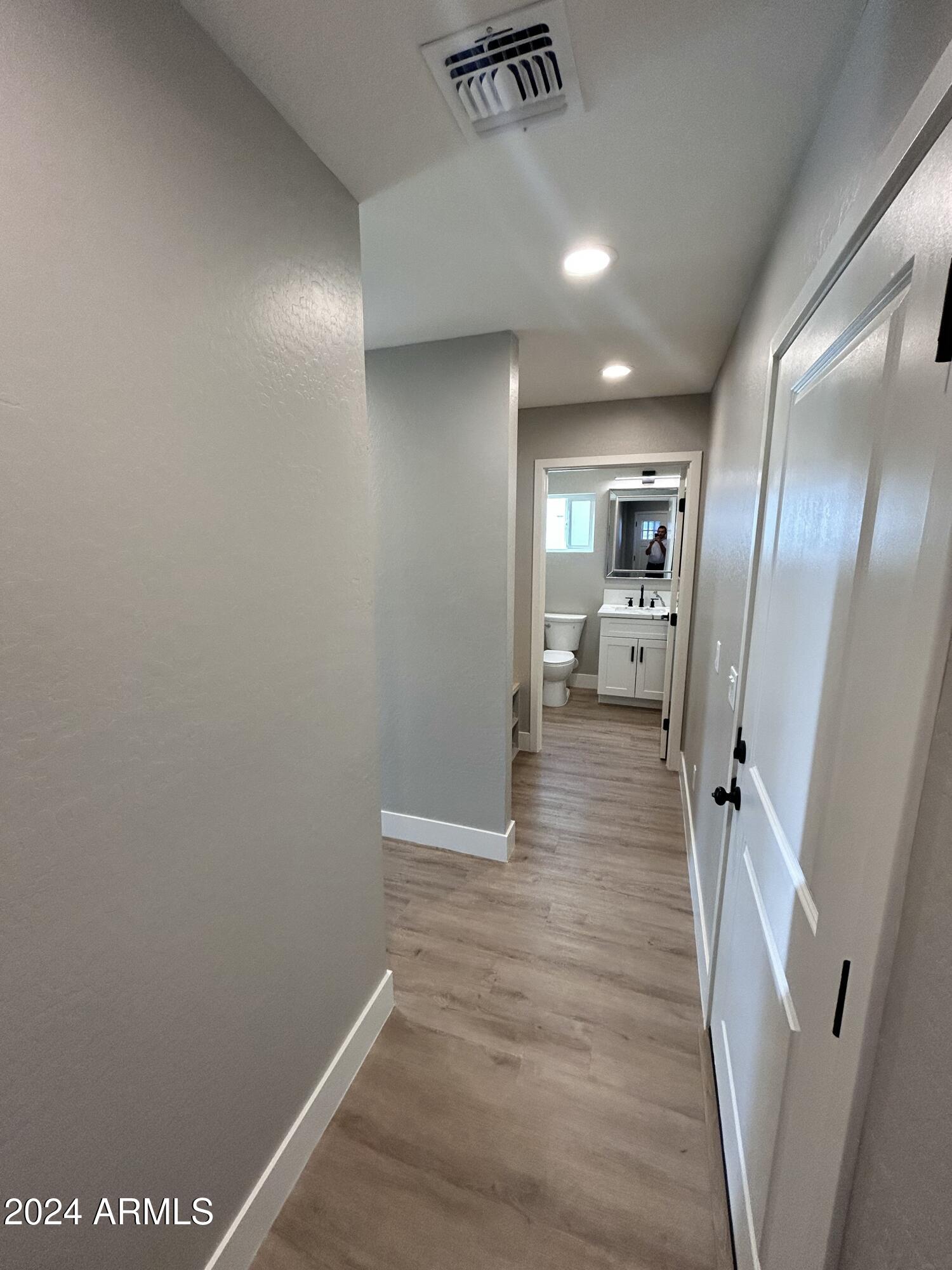 825 West Dobbins Road Phoenix, AZ 85041 - Photo 16 of 99 a view of a hallway with wooden floor