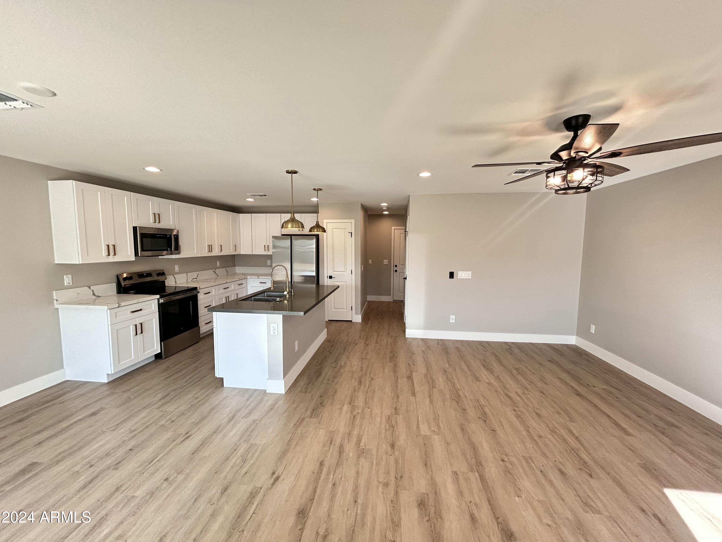 825 West Dobbins Road Phoenix, AZ 85041 - Photo 22 of 99 a view of kitchen with cabinets wooden floor and stainless steel appliances