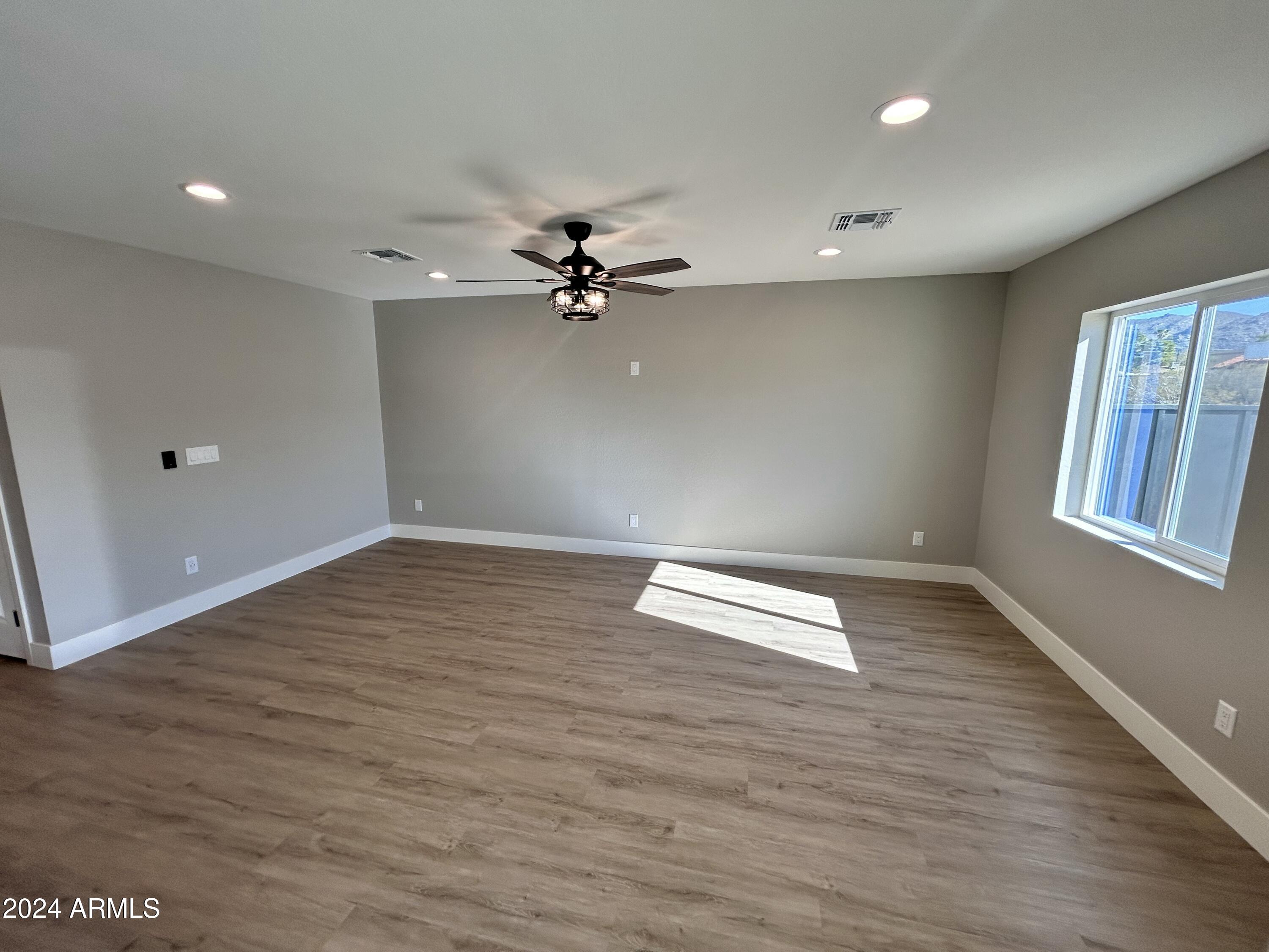 825 West Dobbins Road Phoenix, AZ 85041 - Photo 24 of 99 wooden floor in an empty room with a window