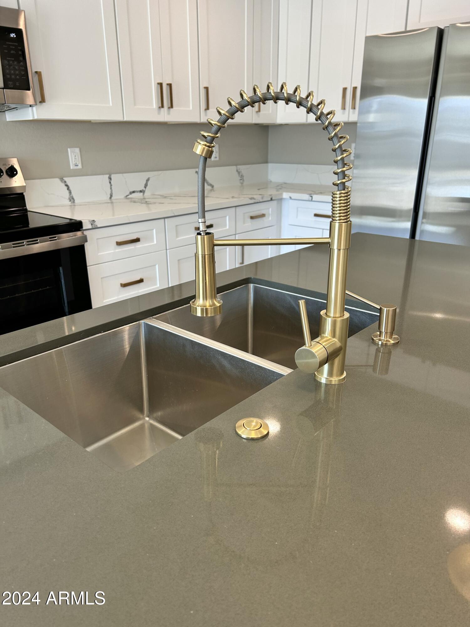 825 West Dobbins Road Phoenix, AZ 85041 - Photo 25 of 99 a kitchen with a sink cabinets and appliances