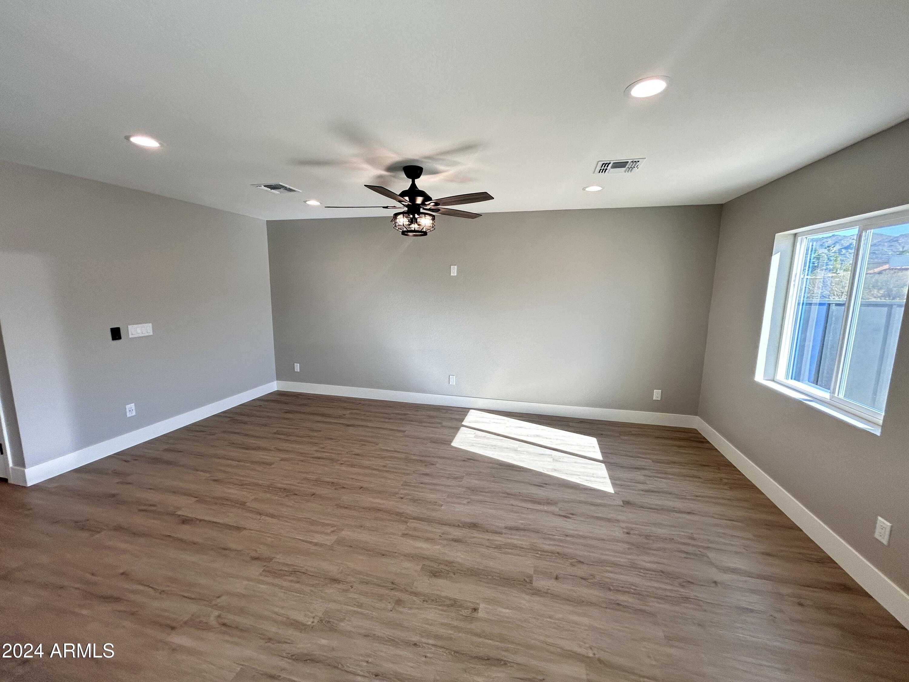 825 West Dobbins Road Phoenix, AZ 85041 - Photo 3 of 99 wooden floor in an empty room with a window