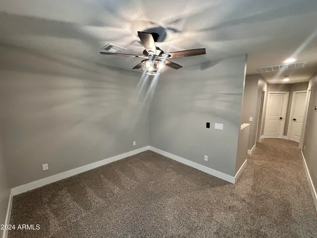 a view of a livingroom with a ceiling fan and window