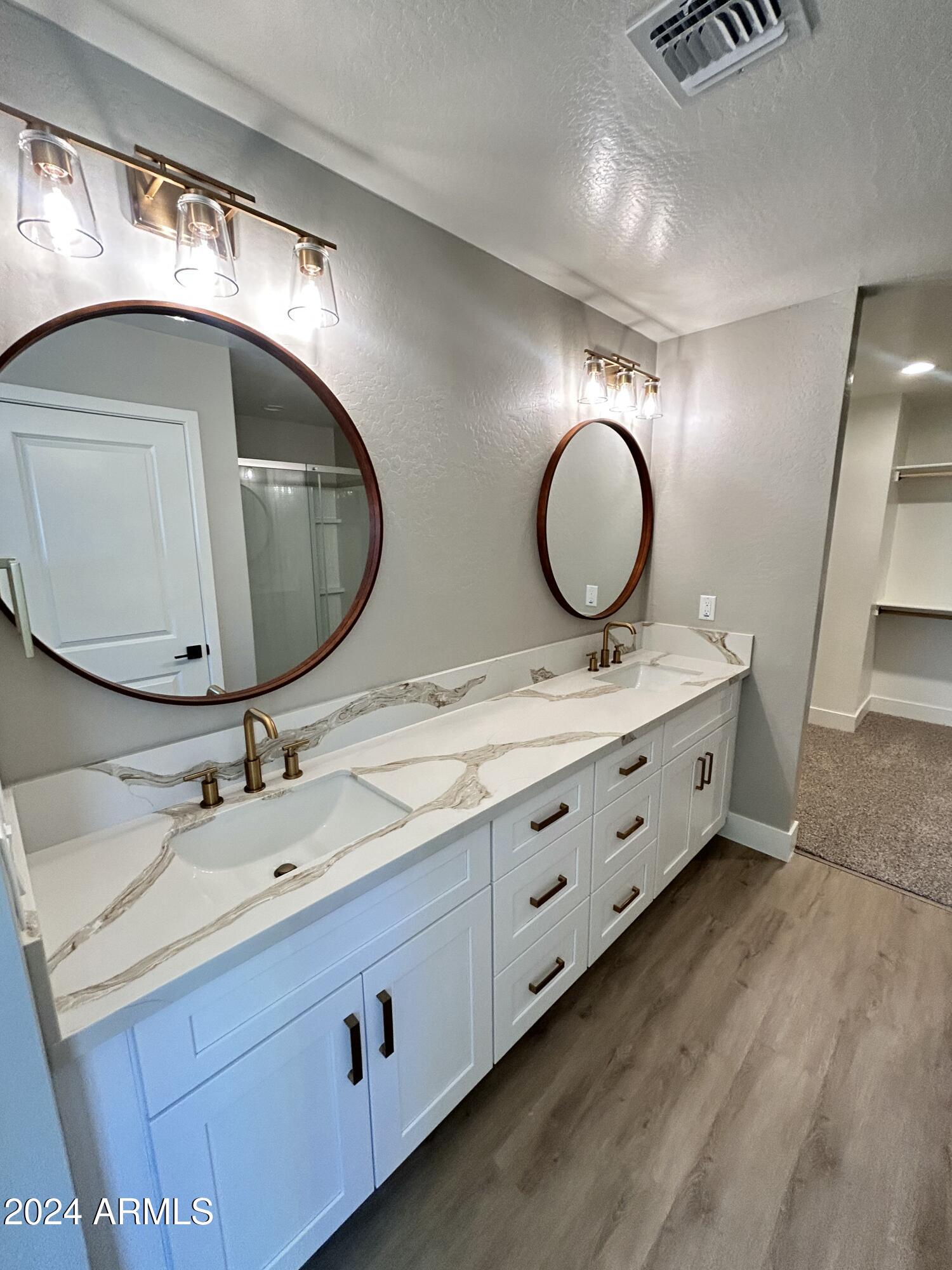 825 West Dobbins Road Phoenix, AZ 85041 - Photo 35 of 99 a bathroom with a double vanity sink and a mirror