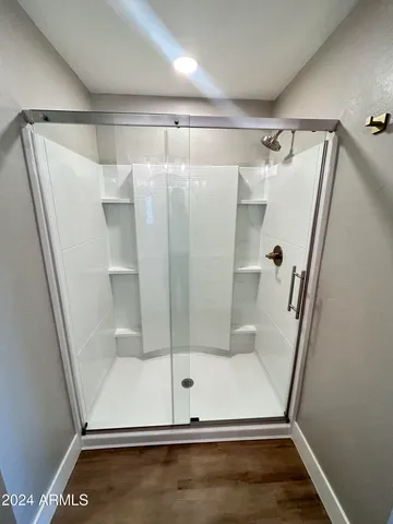 a view of a room with wooden floor and furniture