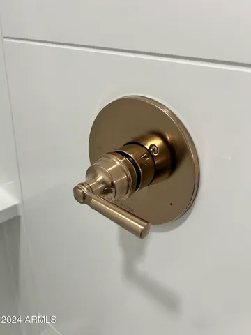 an empty room with a window and a ceiling fan