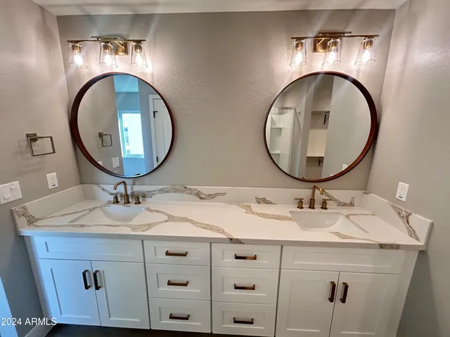 a kitchen with kitchen island wooden floors white cabinets and stainless steel appliances