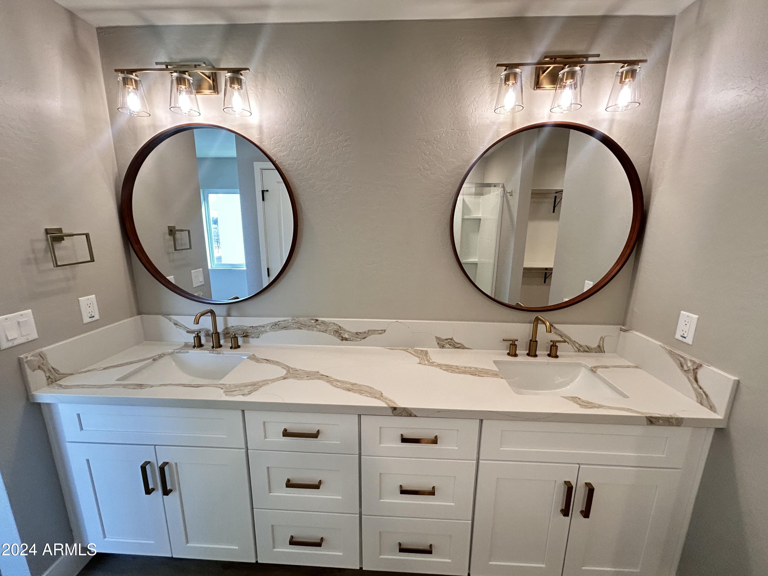 825 West Dobbins Road Phoenix, AZ 85041 - Photo 38 of 99 a bathroom with a sink and a mirror