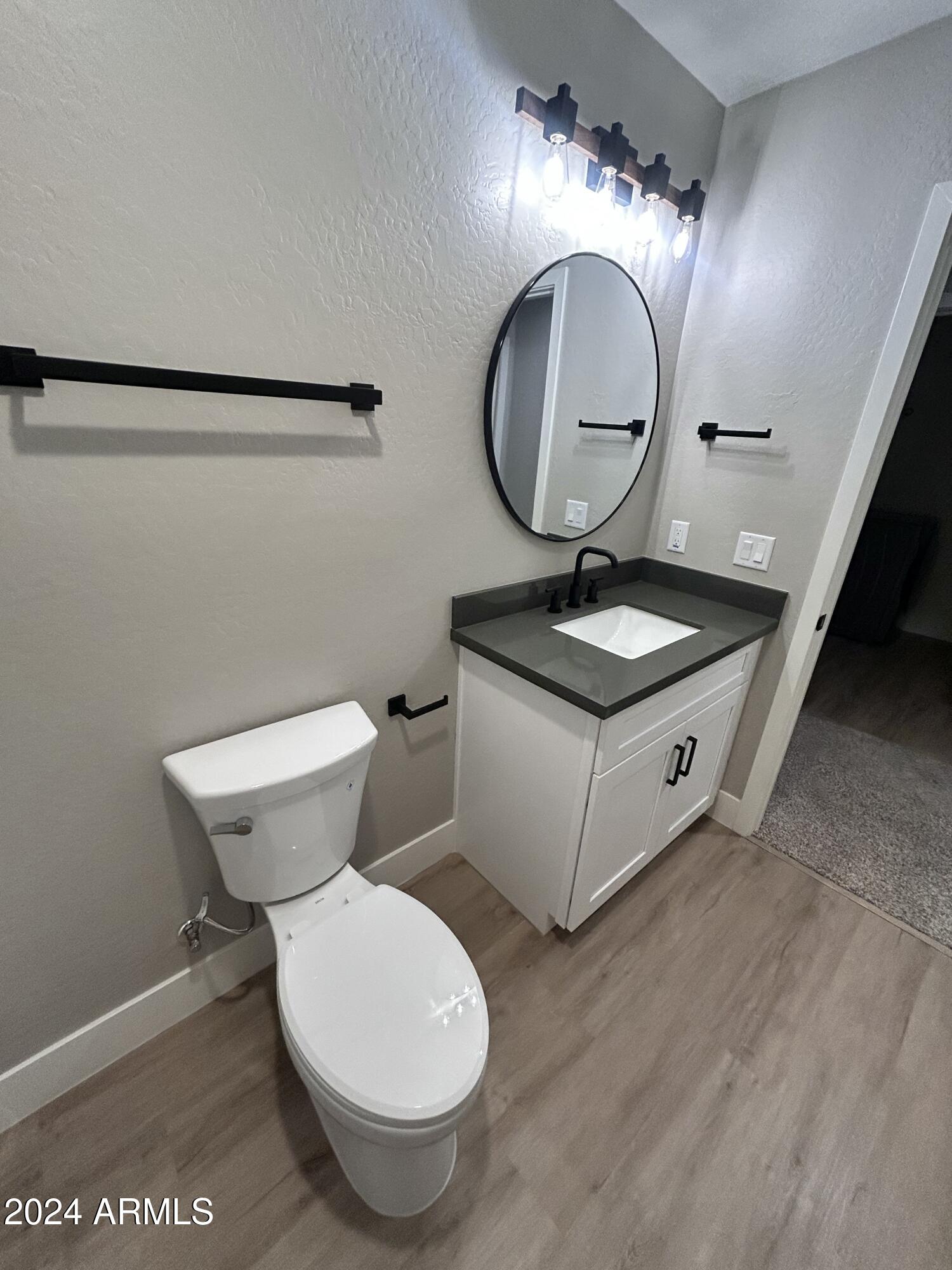 825 West Dobbins Road Phoenix, AZ 85041 - Photo 48 of 99 a bathroom with a toilet sink and mirror