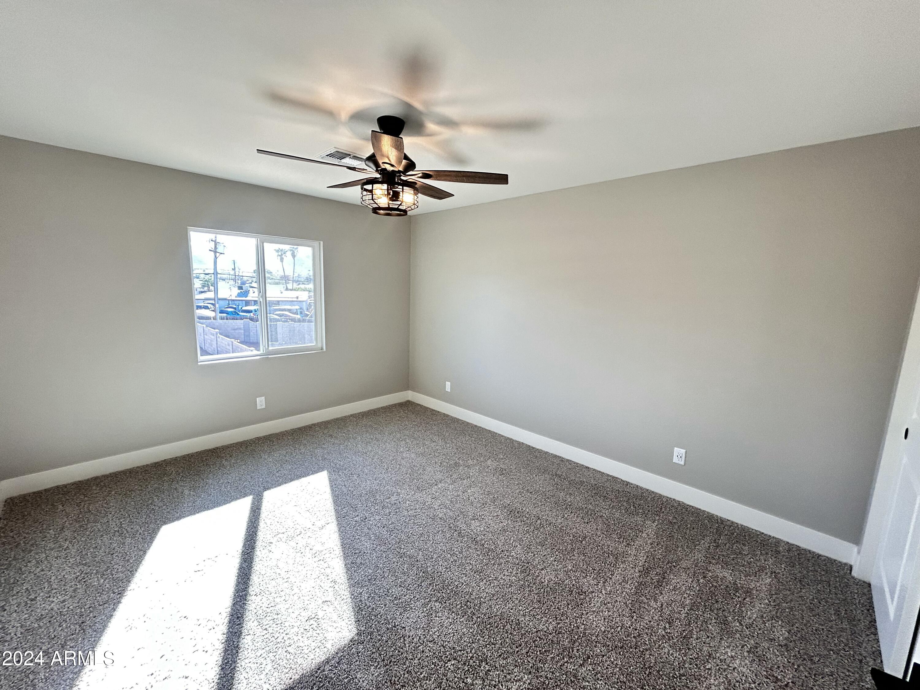 825 West Dobbins Road Phoenix, AZ 85041 - Photo 50 of 99 wooden floor in an empty room with a window