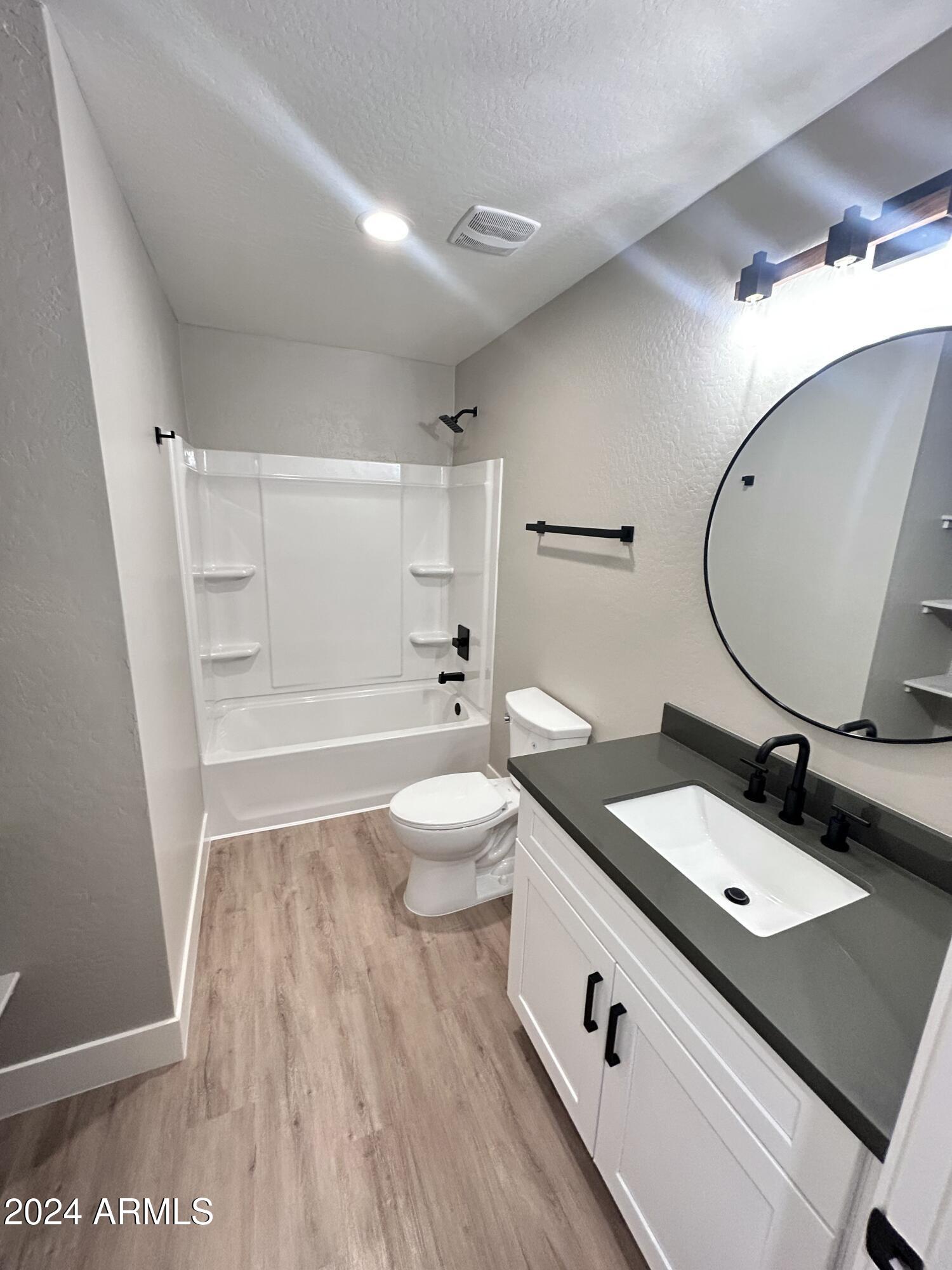 825 West Dobbins Road Phoenix, AZ 85041 - Photo 5 of 99 a bathroom with a granite countertop sink a mirror a toilet and a shower