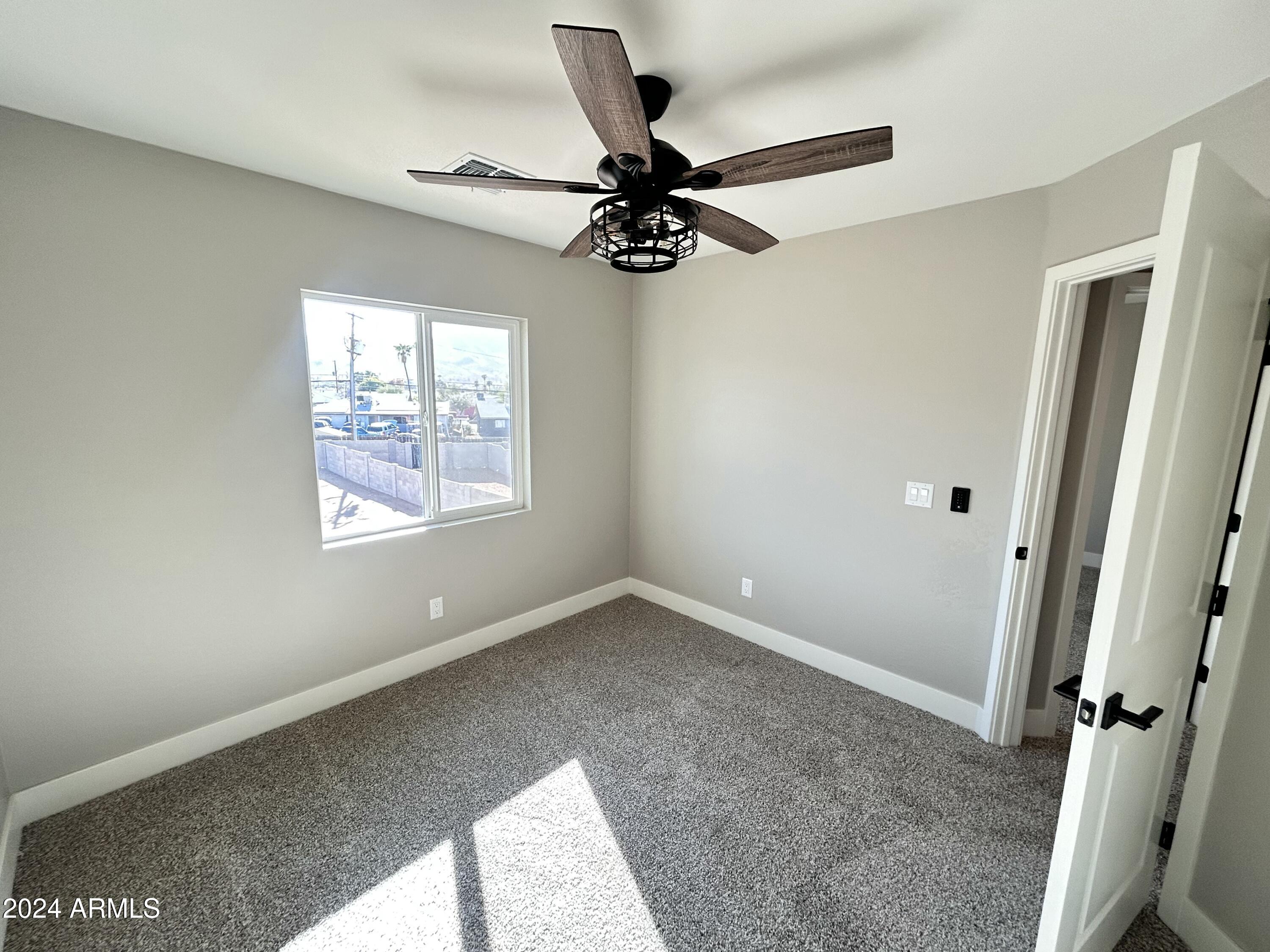 825 West Dobbins Road Phoenix, AZ 85041 - Photo 56 of 99 a view of a livingroom with a ceiling fan and window
