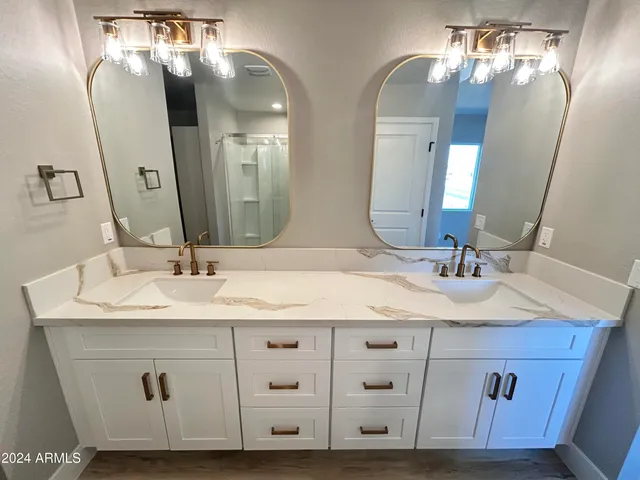 a room with wooden floor and white walls