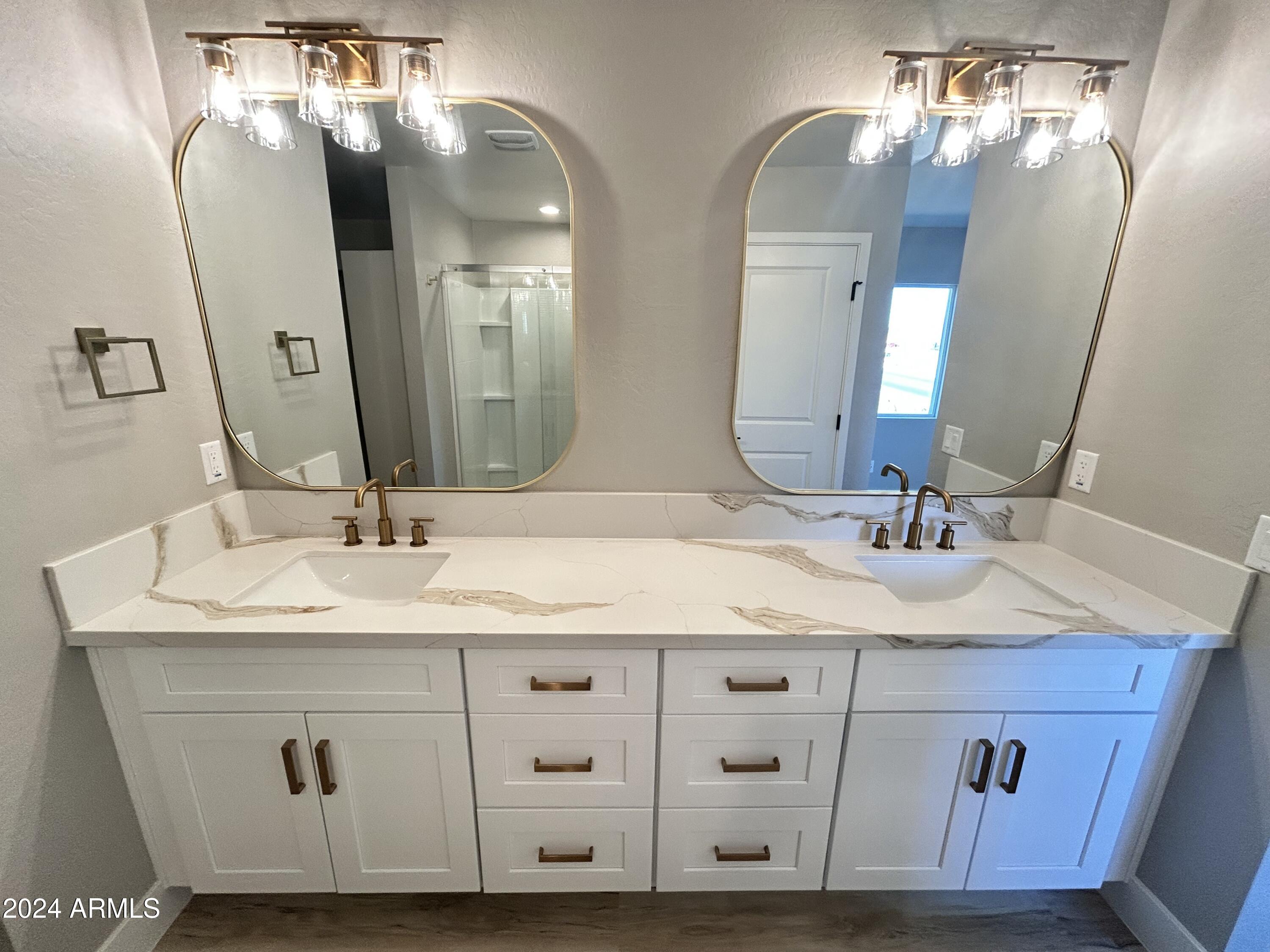 825 West Dobbins Road Phoenix, AZ 85041 - Photo 6 of 99 a bathroom with a double vanity sink and a mirror