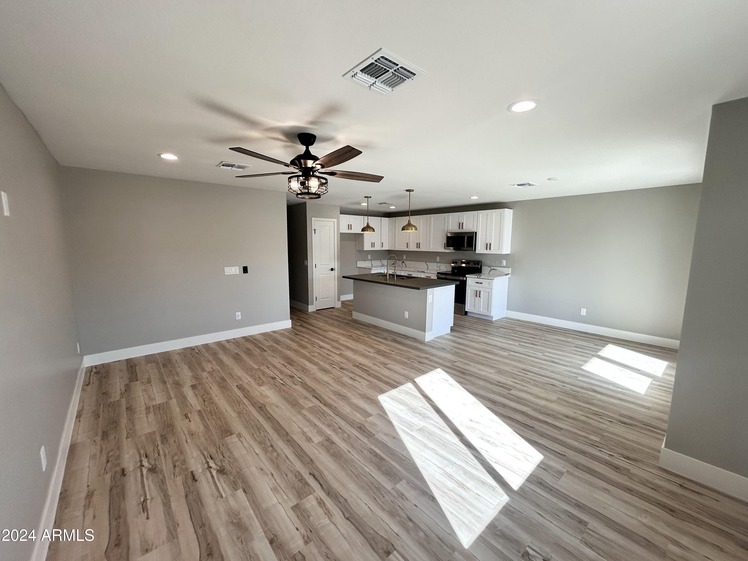 825 West Dobbins Road Phoenix, AZ 85041 - Photo 61 of 99 a view of a room with wooden floor and furniture