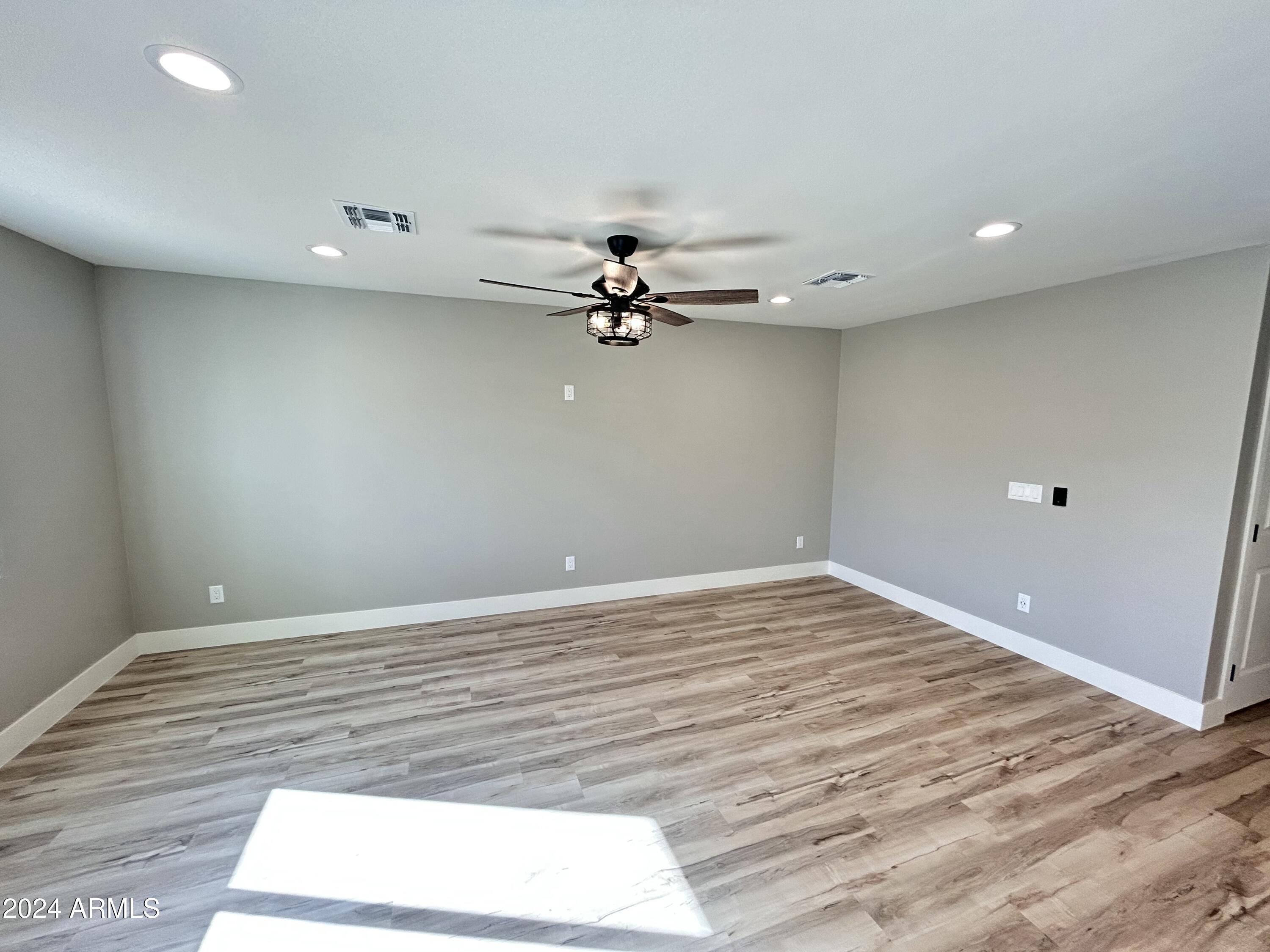 825 West Dobbins Road Phoenix, AZ 85041 - Photo 62 of 99 an empty room with a window and a ceiling fan
