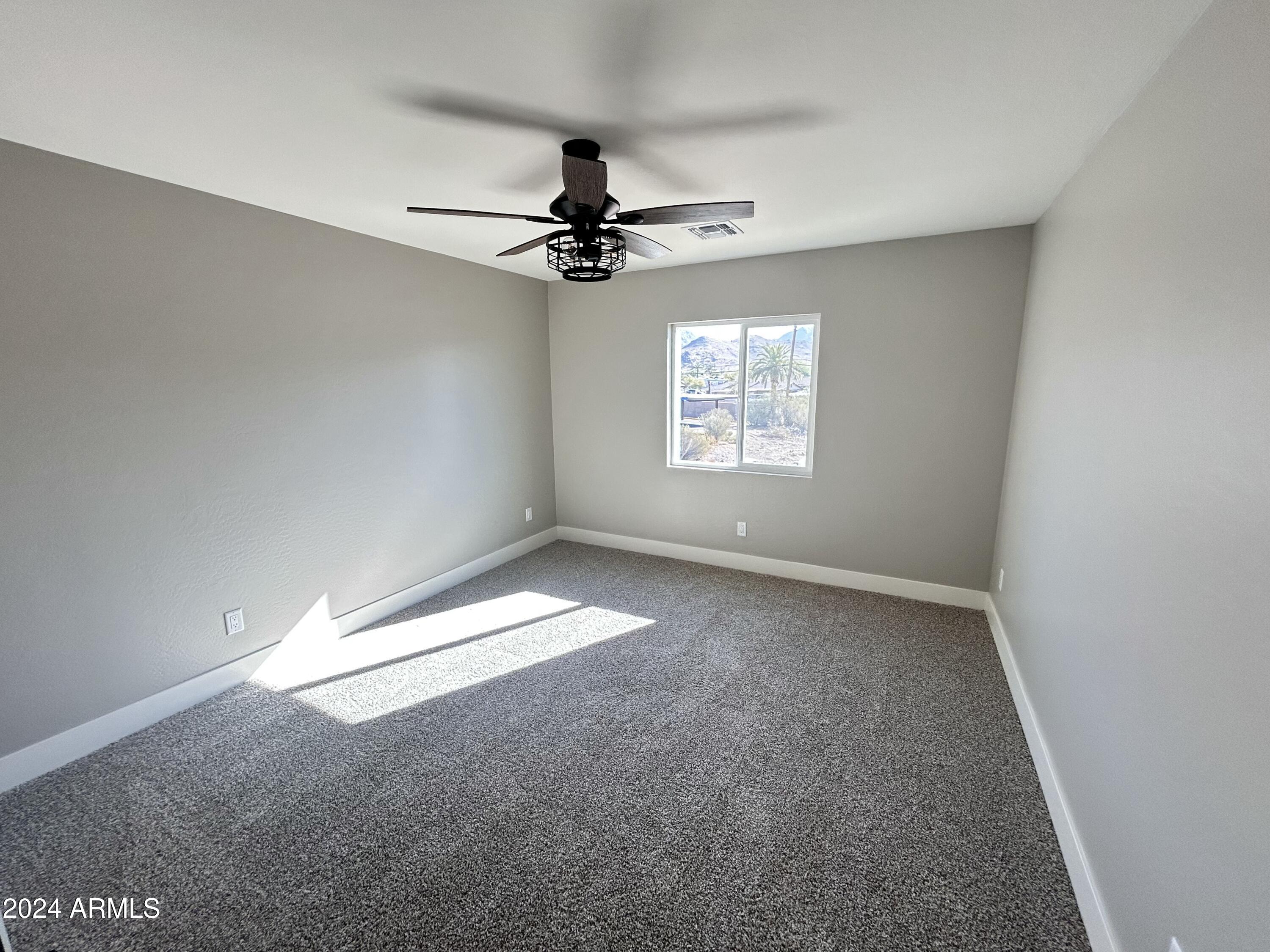 825 West Dobbins Road Phoenix, AZ 85041 - Photo 95 of 99 an empty room with a window and a fan
