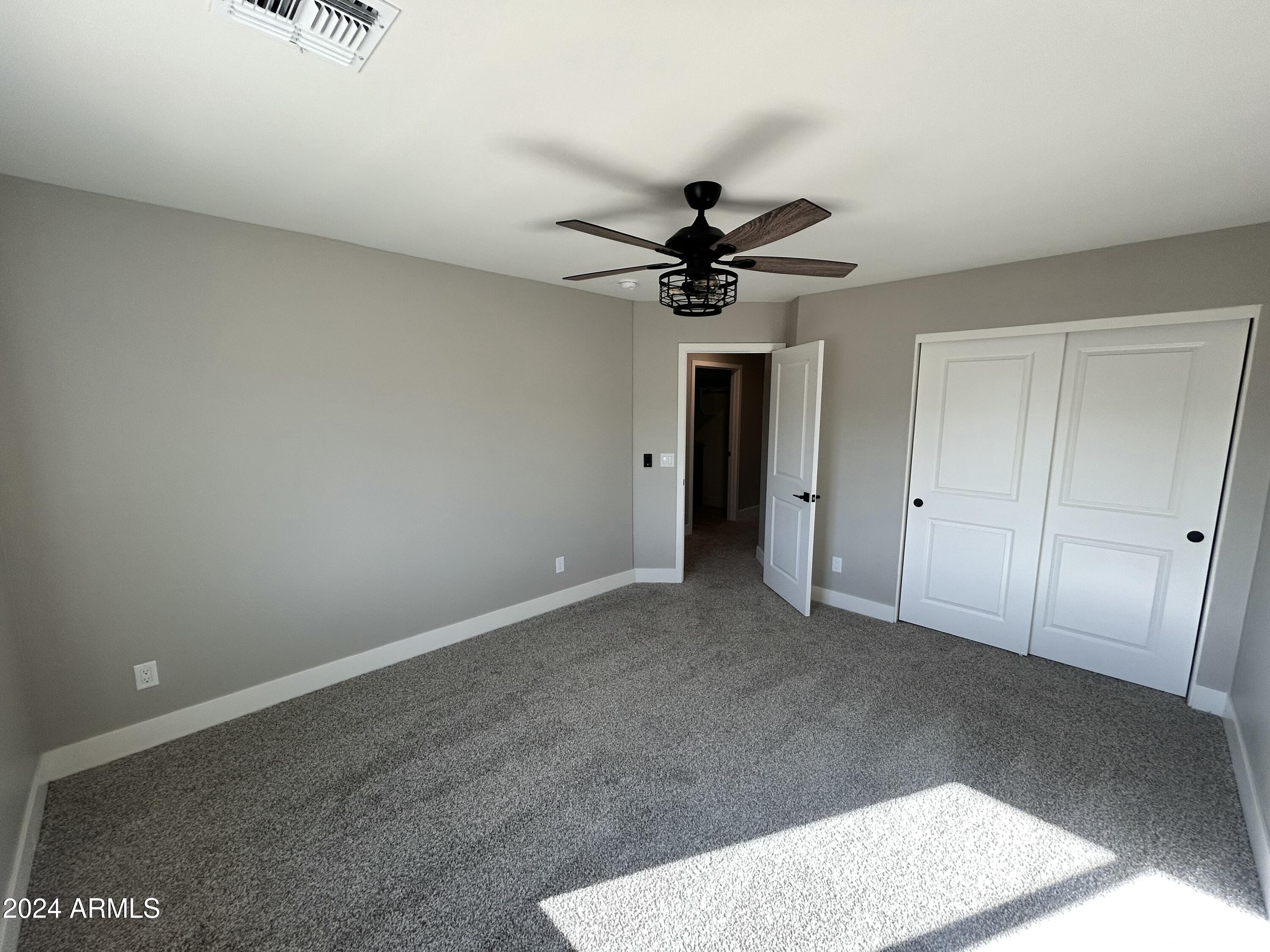 825 West Dobbins Road Phoenix, AZ 85041 - Photo 97 of 99 an empty room with a ceiling fan and a window