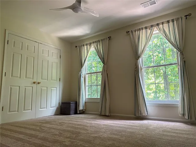 a view of a room with large windows and a chandelier