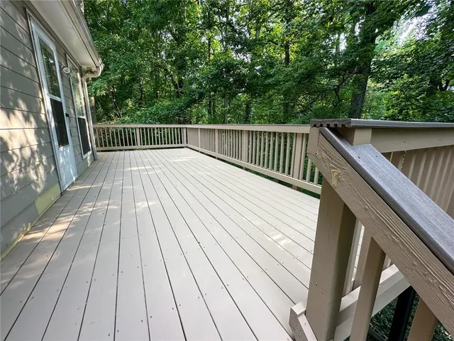 a view of backyard with deck and wooden floor