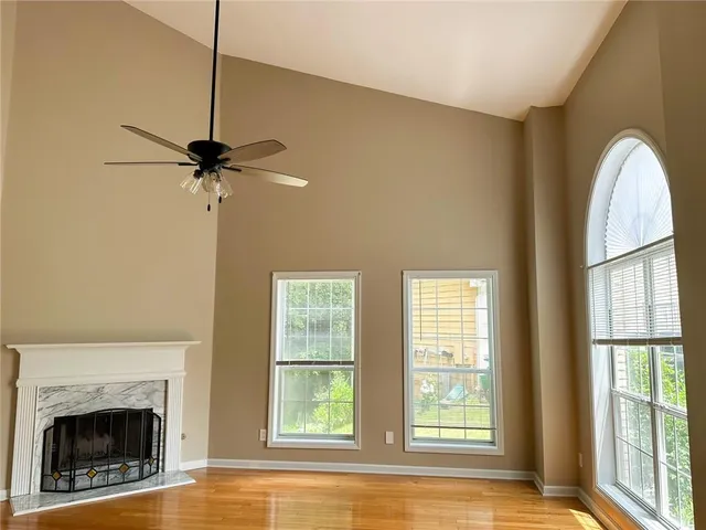 a view of a livingroom with a fireplace and windows
