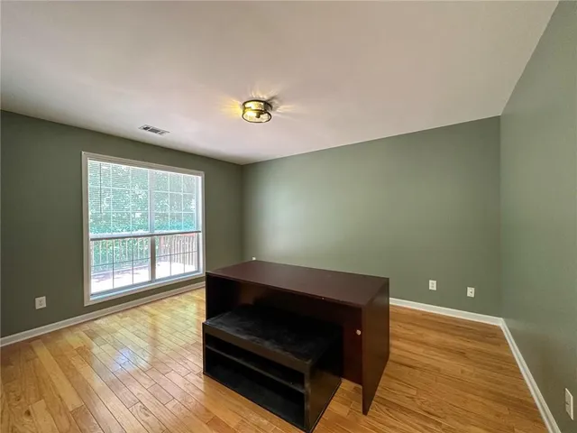 a living room with hard wood floors and a wooden floor