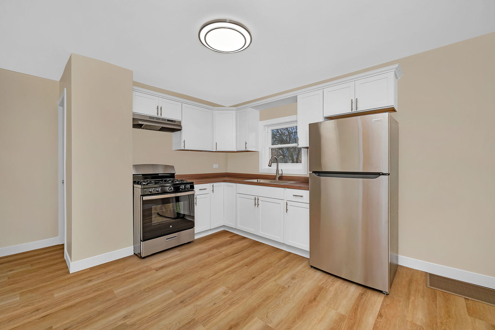 729 Claim Street Aurora, IL 60505 - Photo 21 of 34 a kitchen with a refrigerator and a stove top oven