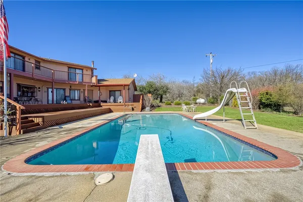 a view of a house with swimming pool and sitting area