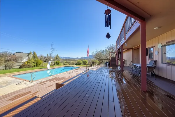 a view of a balcony with wooden fence and floor