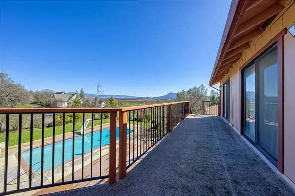 a view of a big yard with table and chairs in patio