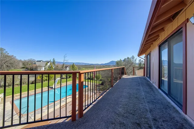 a view of a big yard with table and chairs in patio