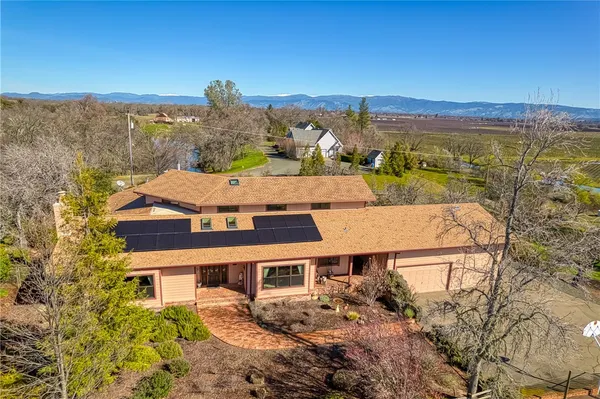an aerial view of a house with a yard