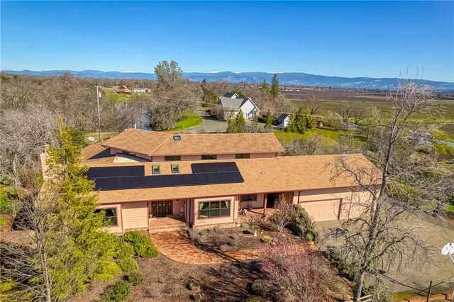 an aerial view of a house with a yard