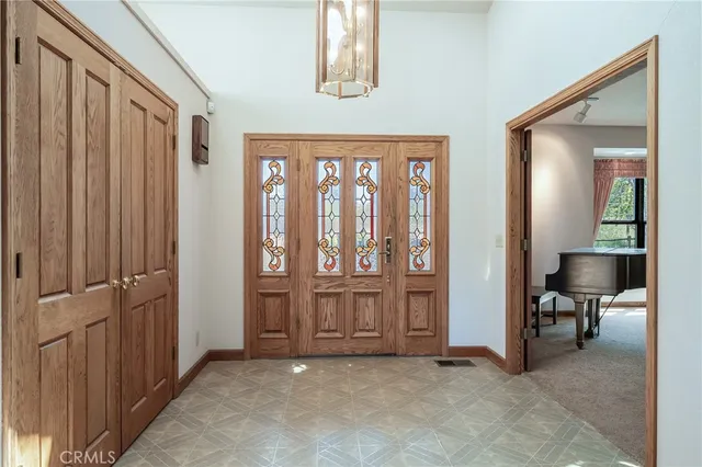 an empty room with a window and a ceiling fan