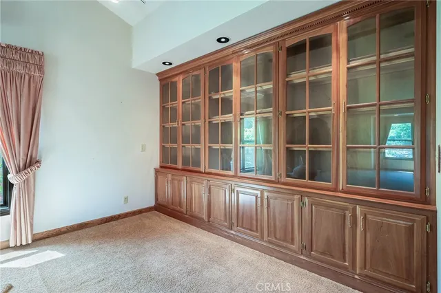 a view of a livingroom with a ceiling fan and window