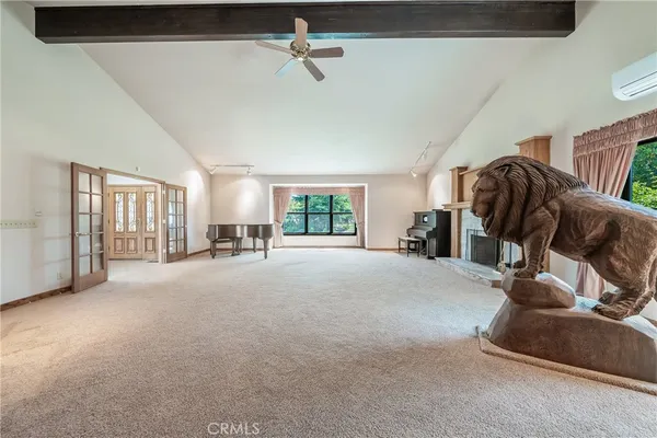 a view of a livingroom with a ceiling fan and window