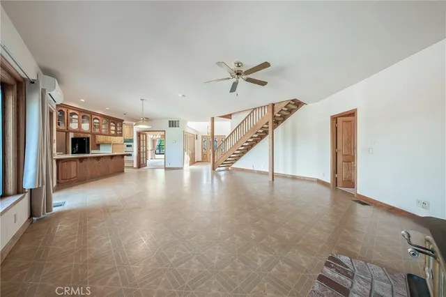 a view of hallway with stairs and wooden floor