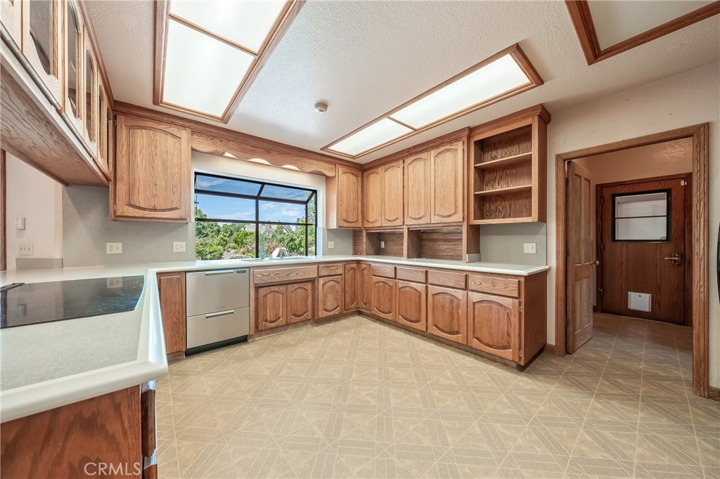 6535 Highland Springs Road Lakeport, CA 95453 - Photo 48 of 75 a kitchen with stainless steel appliances a large window and a counter top space