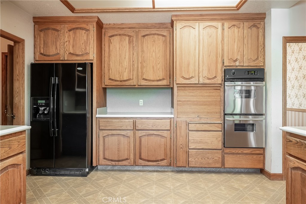 6535 Highland Springs Road Lakeport, CA 95453 - Photo 52 of 75 a kitchen with granite countertop a refrigerator and cabinets