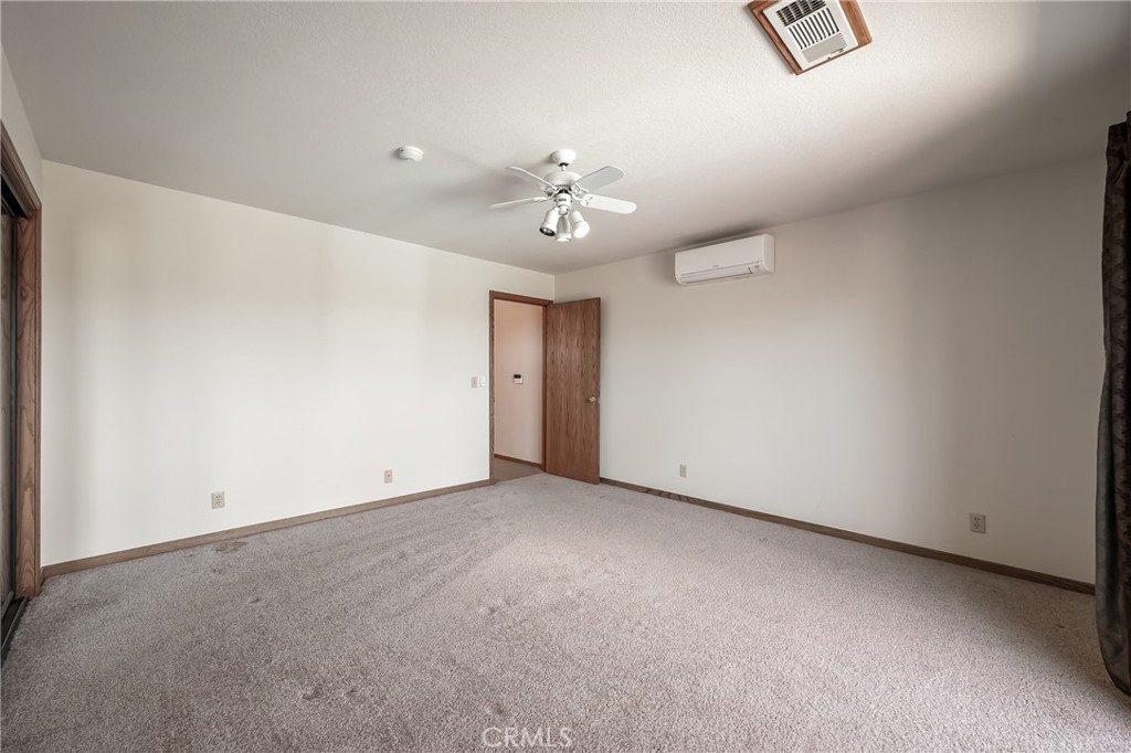 6535 Highland Springs Road Lakeport, CA 95453 - Photo 66 of 75 an empty room with chandelier fan and windows