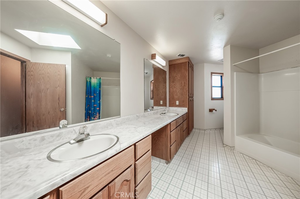 6535 Highland Springs Road Lakeport, CA 95453 - Photo 68 of 75 a bathroom with a granite countertop sink and a mirror