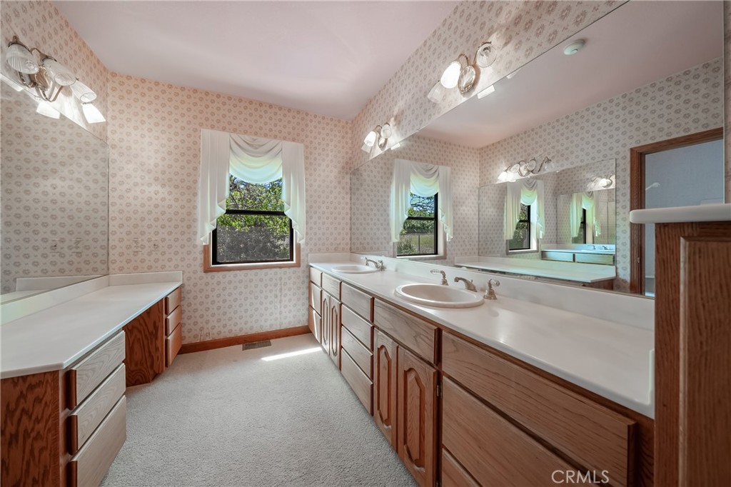 6535 Highland Springs Road Lakeport, CA 95453 - Photo 71 of 75 a spacious bathroom with a granite countertop sink a toilet a mirror and window
