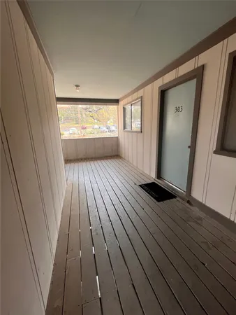 a view of a room with wooden floor