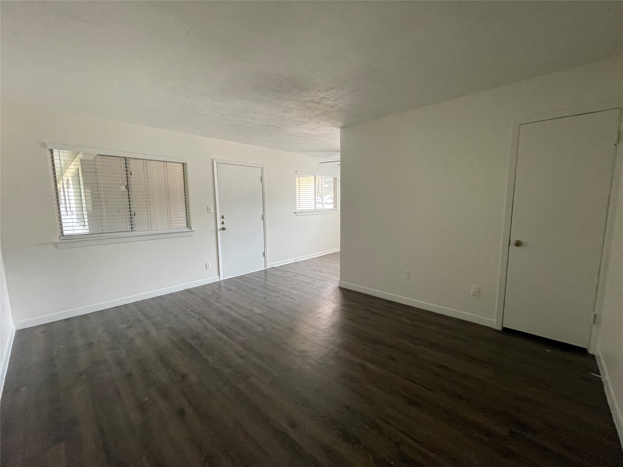 3106 Duval Street, Unit 303 Austin, TX 78705 - Photo 5 of 13 an empty room with wooden floor and windows