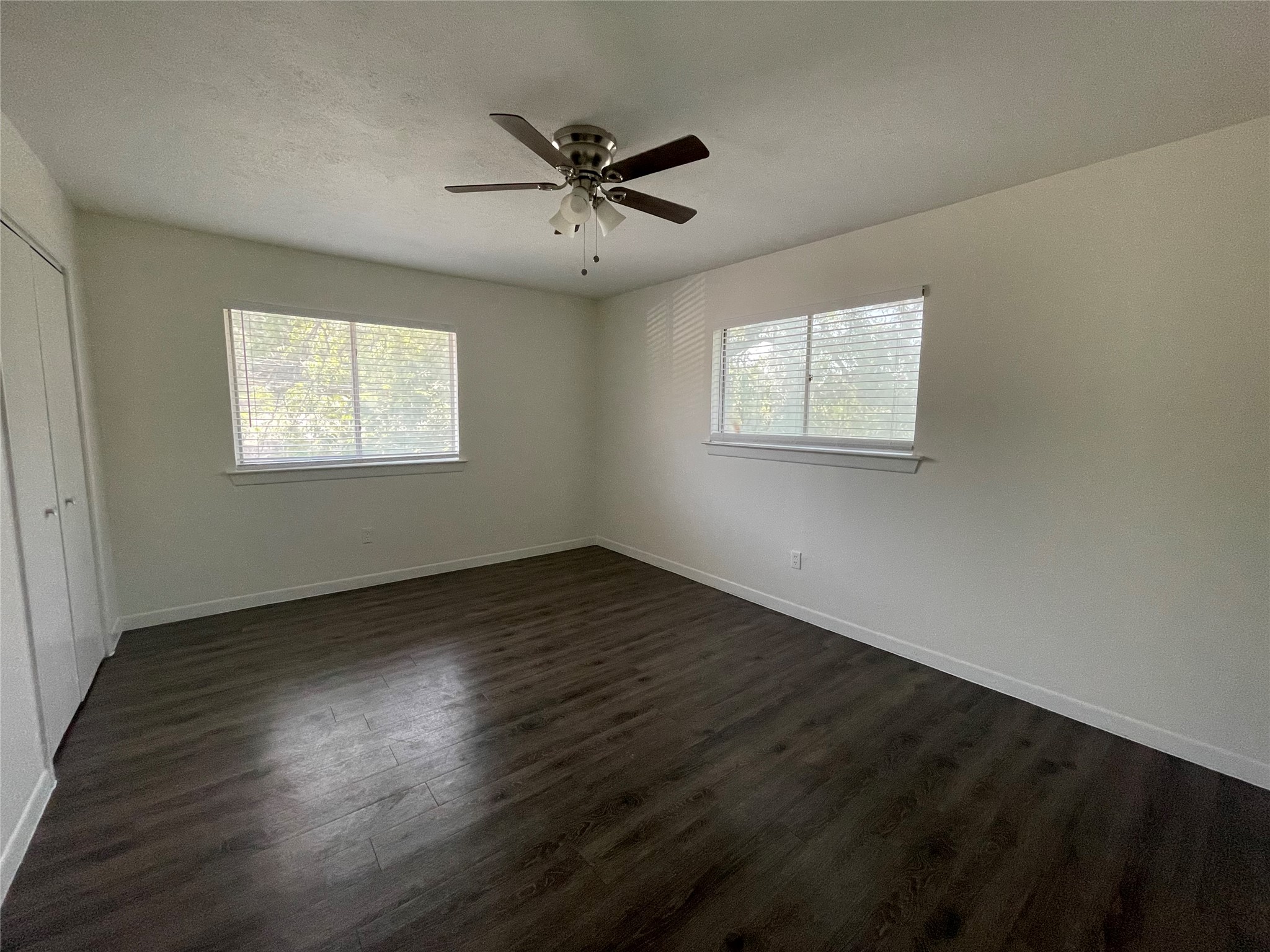 3106 Duval Street, Unit 303 Austin, TX 78705 - Photo 7 of 13 a view of an empty room with wooden floor and a window