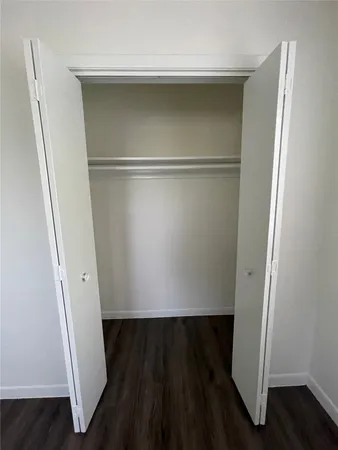 a view of closet with wooden floor