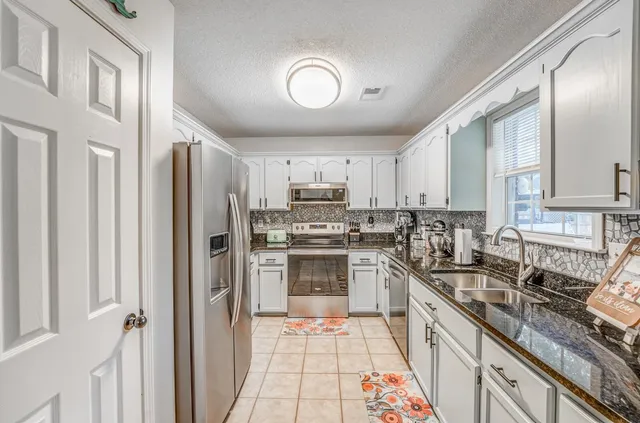 a kitchen with sink cabinets and window