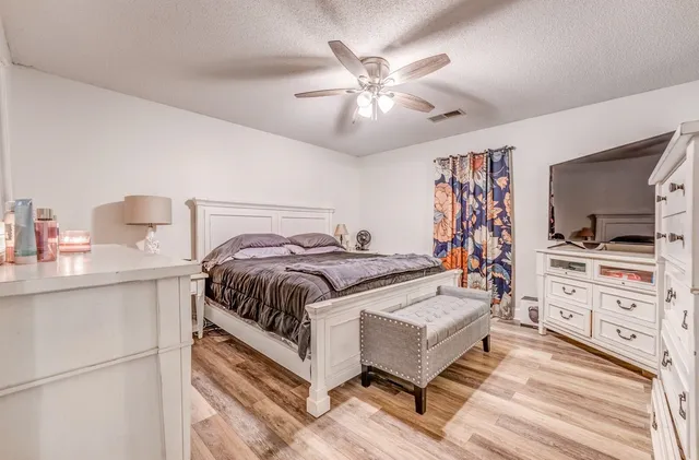 a bedroom with a bed and a chandelier
