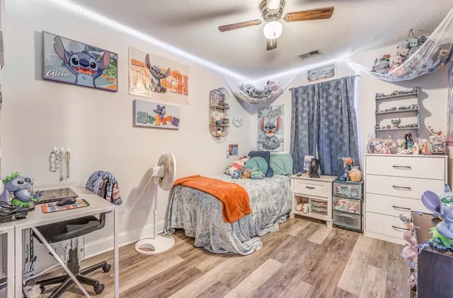 a bedroom with furniture and a baby crib
