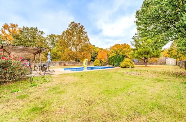 a view of a swimming pool with an outdoor space and seating area